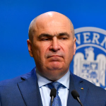 ---------PSD-l-acuz-pe-Bolojan-de-trafic-de-influen-firma-de-avocatur-care-a-oferit-consultan-Guvernului-ar-fi-reprezentat-i-o-companie-militar-german-